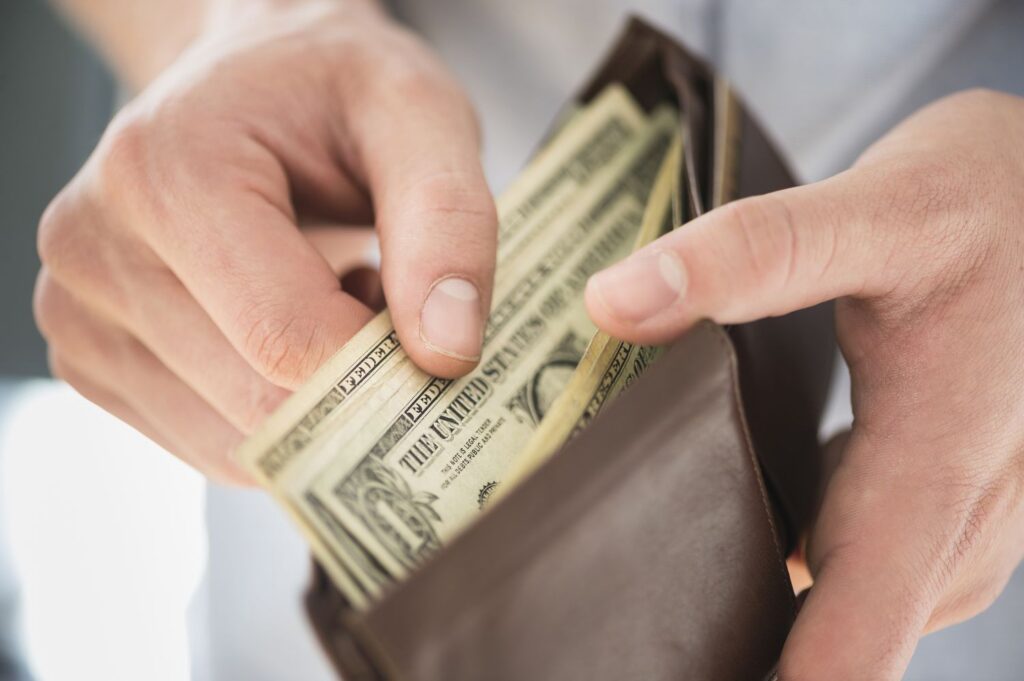 Man pulling cash from wallet