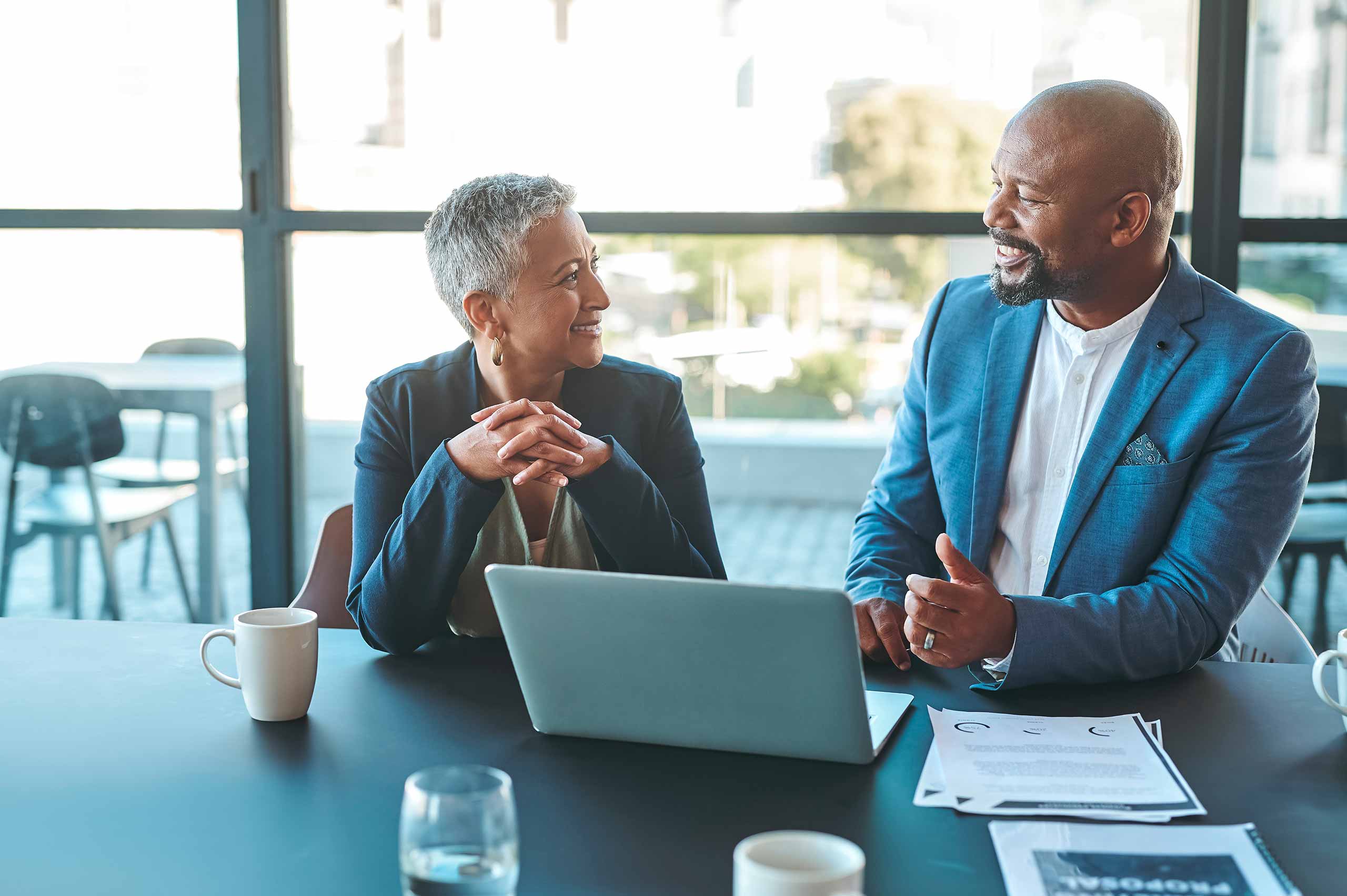 Financial advisor consulting with retired client in office